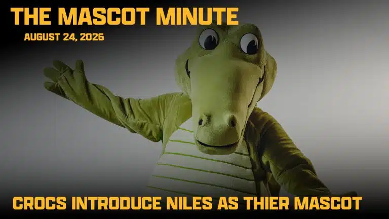 A person in a green crocodile mascot costume poses with arms wide. Text reads: THE MASCOT MINUTE August 24, 2026. Catch all the excitement as The Mascot Minute announces—CROCS INTRODUCE NILES AS THEIR MASCOT.