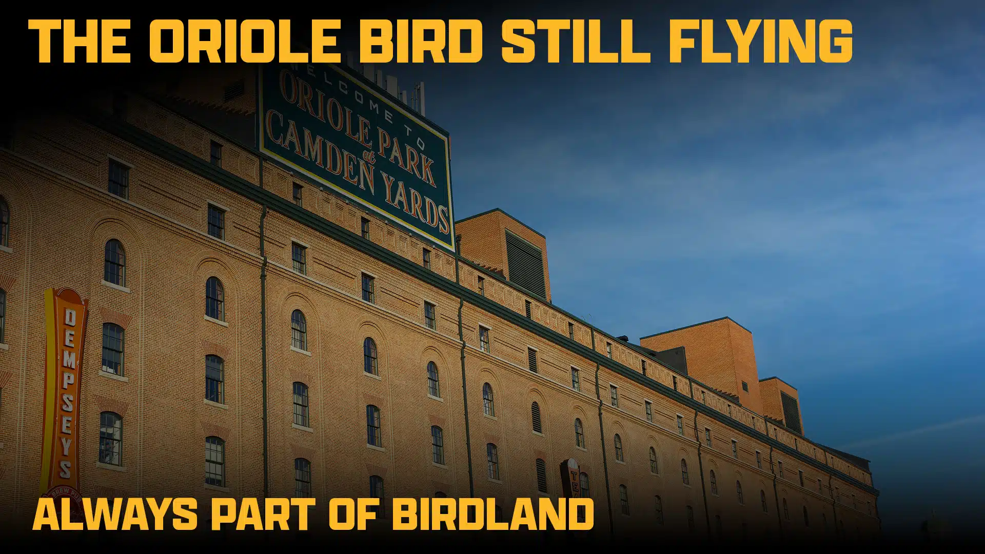 The exterior of the Baltimore Orioles warehouse at Camden Yards, with text overlay reading The Oriole Bird still flying and Always part of Birdland.